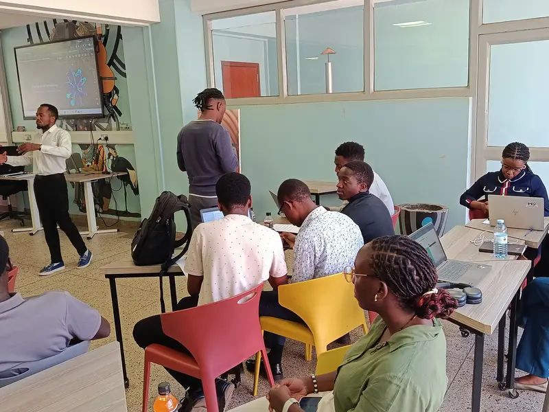 A facilitator guiding groups working at their laptops