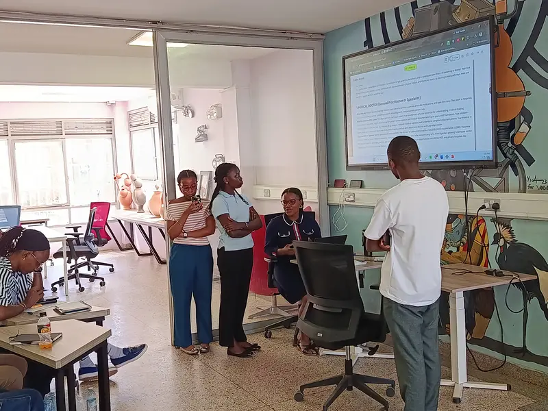 A team pitching their project in front of the screen